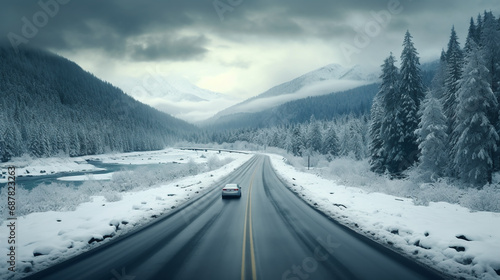 Snowy winter landscape with a car on the road. Car on the road in the winter forest at sunset. Car travel concept. Aerial view of winter forest and road at sunset. Beautiful winter landscape. travel
