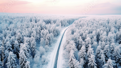 Snowy winter landscape. road in the winter forest at sunset. travel concept. Aerial view of winter forest and road at sunset. Beautiful winter landscape. travel