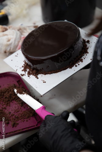 Baking of petite gateau in dessert kitchen. Bright kitchen environment. Pastry chef making finely crafted dessert. Human hand at work. photo