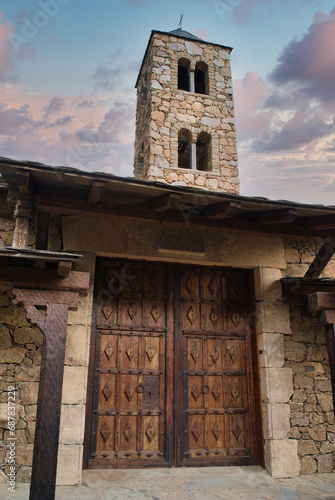 Church and bell tower Sant Ivo, in a very small village Auvinya, Andorra Romanesque style. photo