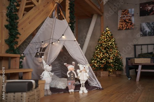Teepee tent in the nursery room at christmas holidays with christmas tree