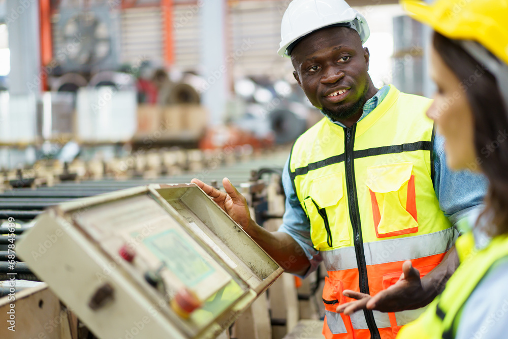Team of mechanical engineer working together in the factory, engineers inspecting a metal machine system the factory. Team of mechanical engineer working together in the factory, engineers inspecting a metal machine system the factory.