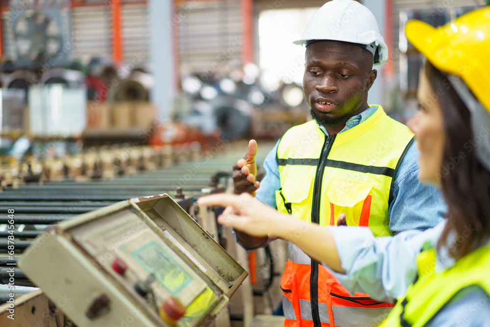Team of mechanical engineer working together in the factory, engineers inspecting a metal machine system the factory. Team of mechanical engineer working together in the factory, engineers inspecting a metal machine system the factory.