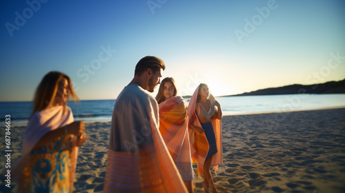man and two women stroll on beach at sunset, casual joy, fictional location