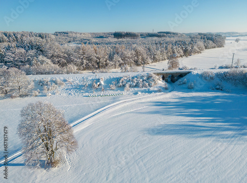 Fototapeta Naklejka Na Ścianę i Meble -  Aerial view of a snow-covered winter wonderland in southern Bavaria, Germany 