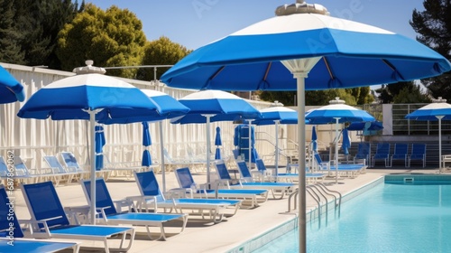 A row of lawn chairs and umbrellas next to a swimming pool