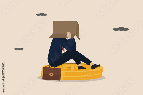 Financial problems, failure, unemployment, bankrupt office worker, economic crisis, depressed unemployed businessman sitting on dollar coins and covering his head in shame.
