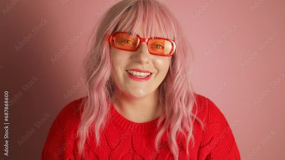 Young attractive sweet young pink hair woman wear red sweater dancing enjoying new year time isolated pink color background. High quality FullHD footage Young attractive sweet young pink hair woman wear red sweater dancing enjoying new year time isolated pink color background. High quality FullHD footage