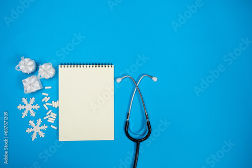 Christmas and New Year Medical Greeting Card, Notebook with Space for Text, Blue Background, Top View. photo