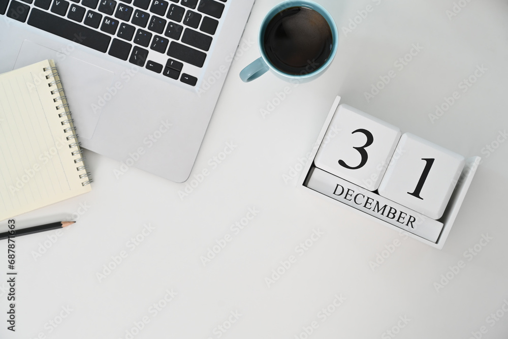 Wooden block calendar with the date December 31 on white background