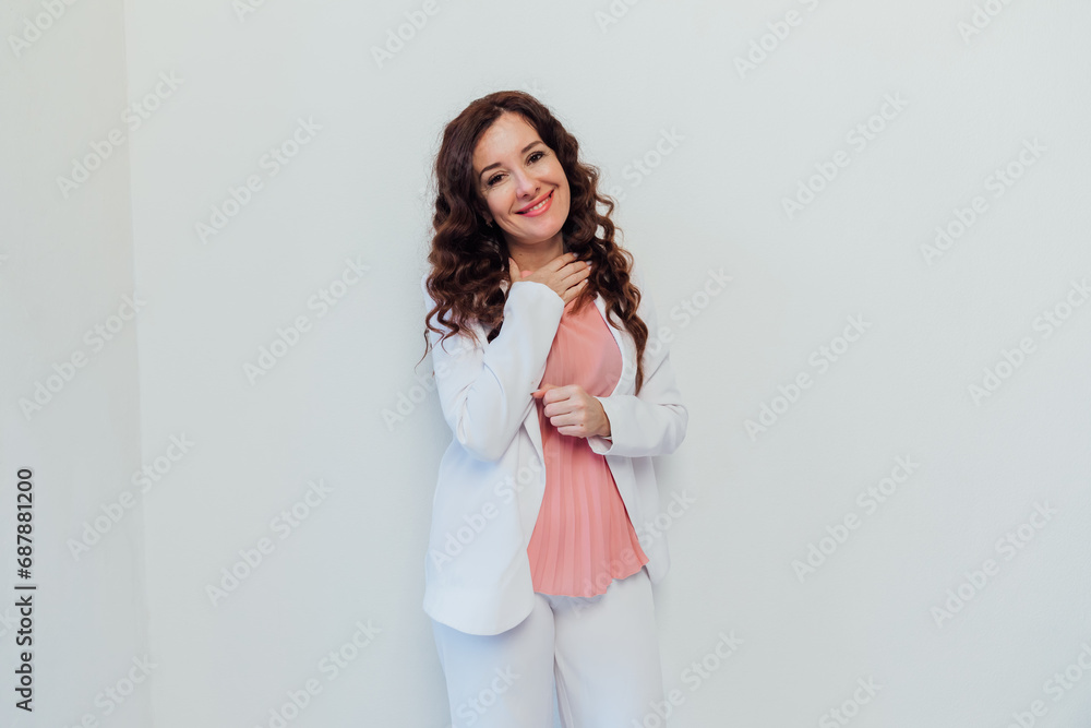 Beautiful brunette woman in white suit posing in bright studio Beautiful brunette woman in white suit posing in bright studio