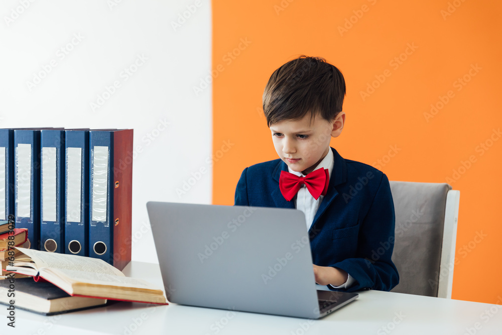 Boy schoolboy studying at the computer online education lessons Boy schoolboy studying at the computer online education lessons