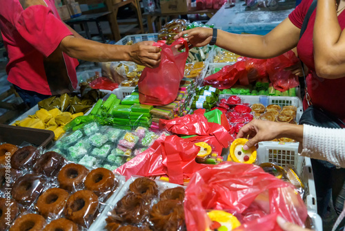 Many varieties of traditional snacks sold in the Marketplace in dawn time in Surabaya, East Java, Indonesia. photo