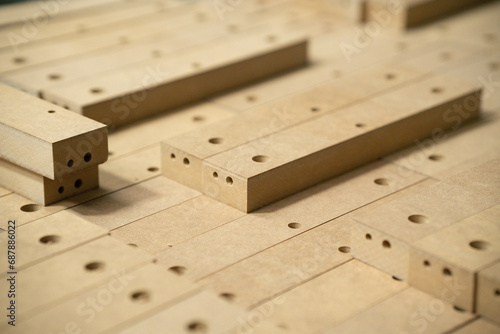 Close up of wooden parts in in big furniture manufacturing facility. Wooden parts for the production of chairs in the warehouse of a furniture factory. photo