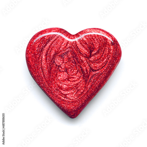 Red metallic shimmering nail polish in heart shape composition texture isolated on white background. Cosmetic makeup product photo