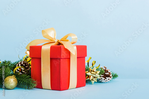 New Year Christmas mood  gift box  branches of a christmas tree  New Year decorations on a colored background