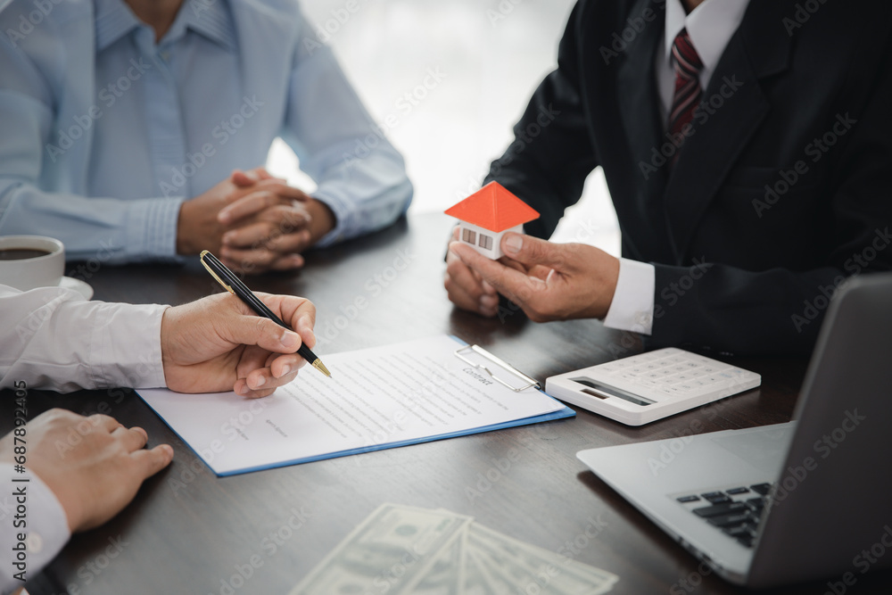 Real estate broker agent presenting and consult to customer, buy and sell home model, concerning mortgage loan offer for and house insurance. Real estate broker agent presenting and consult to customer, buy and sell home model, concerning mortgage loan offer for and house insurance.