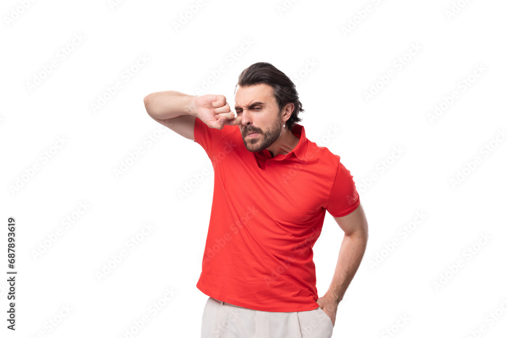 young confused man with black hair and beard dressed in a red corporate t-shirt young confused man with black hair and beard dressed in a red corporate t-shirt