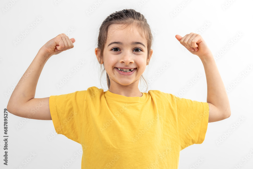 Little girl hand flexing demonstrating biceps isolated on white background. Little girl hand flexing demonstrating biceps isolated on white background.