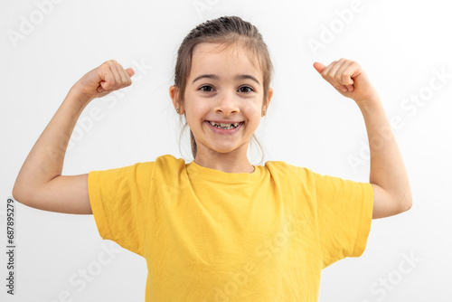 Little girl hand flexing demonstrating biceps isolated on white background.