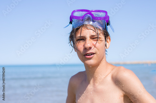 Portrait of Teenager's smiling face with a diving mask captures the carefree spirit of a summer beach outing,copyspace.