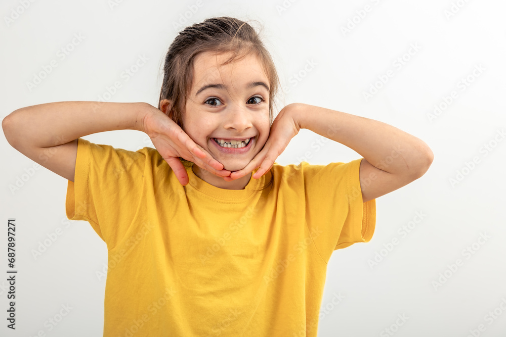 Portrait little girl keeping hands near face, smiling isolated on white. Portrait little girl keeping hands near face, smiling isolated on white.