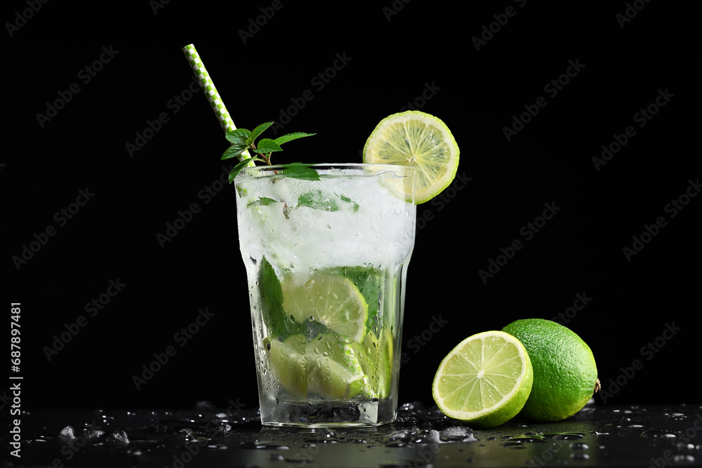 Glass with mojito cocktail and limes Glass with mojito cocktail and limes