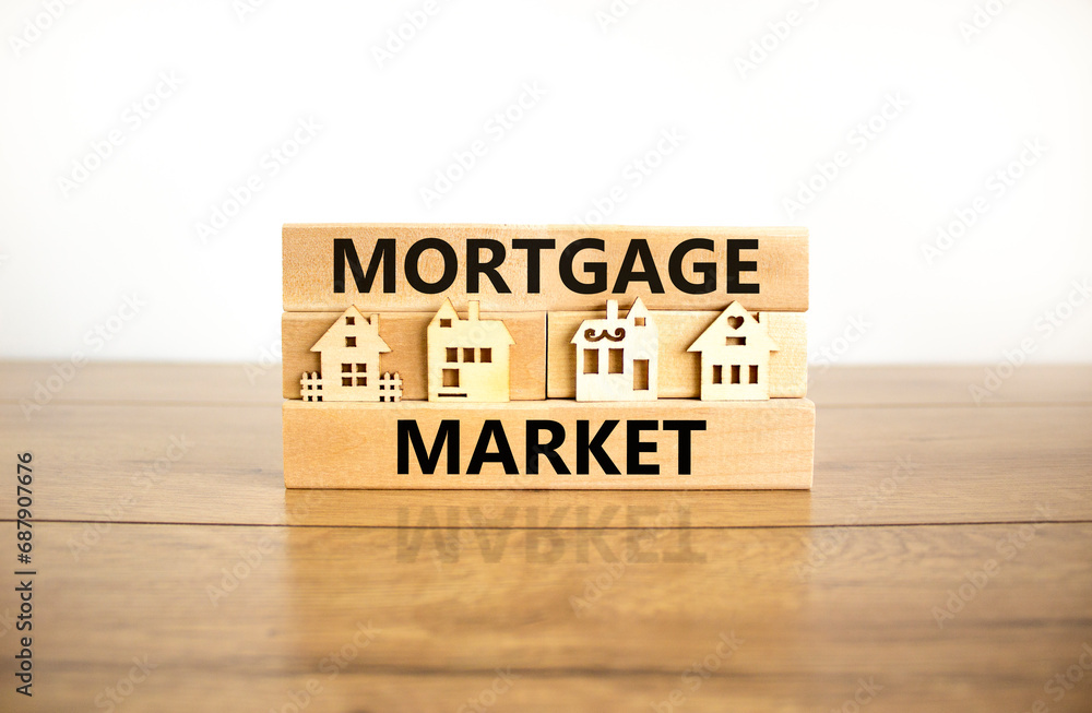 Mortgage market symbol. Concept words Mortgage market on beautiful wooden blocks. Beautiful wooden table white background. House model. Business mortgage market concept. Copy space. Mortgage market symbol. Concept words Mortgage market on beautiful wooden blocks. Beautiful wooden table white background. House model. Business mortgage market concept. Copy space.