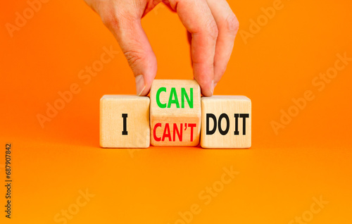 I can do it symbol. Concept word I can or can not do it on beautiful wooden cubes. Beautiful orange table orange background. Businessman hand. Business and i can or not do it concept. Copy space.