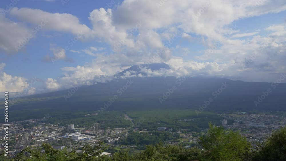 Capture the essence of Fuji mountain during daylight in this cinematic daytimelapse, framed by an expansive cloud, unveiling the city beneath. Capture the essence of Fuji mountain during daylight in this cinematic daytimelapse, framed by an expansive cloud, unveiling the city beneath.