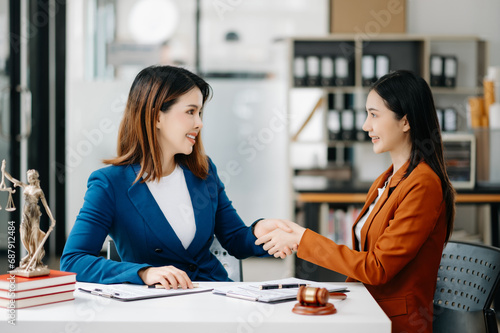 Wallpaper Mural Consultation between a female lawyer and business customer, handshake after good deal agreement, Law and Legal concept. Torontodigital.ca