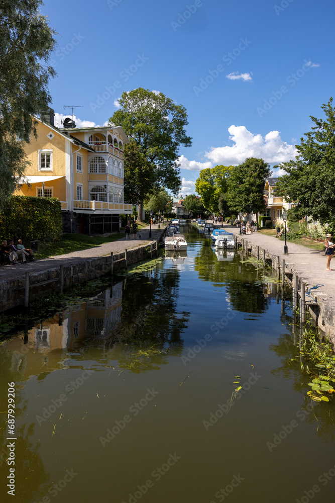 Obraz premium View of the Trosa river with moored pleasure boats in the picturesque seaside town of Trosa in Södermanland. Sweden.