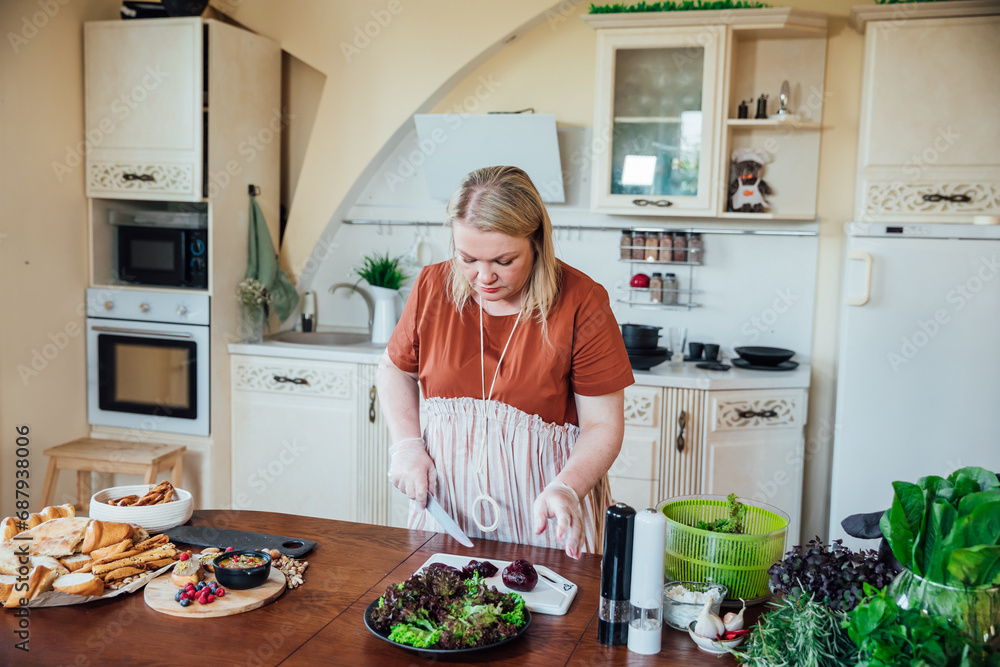 Woman cook at home in kitchen preparing vegetable salad for eating