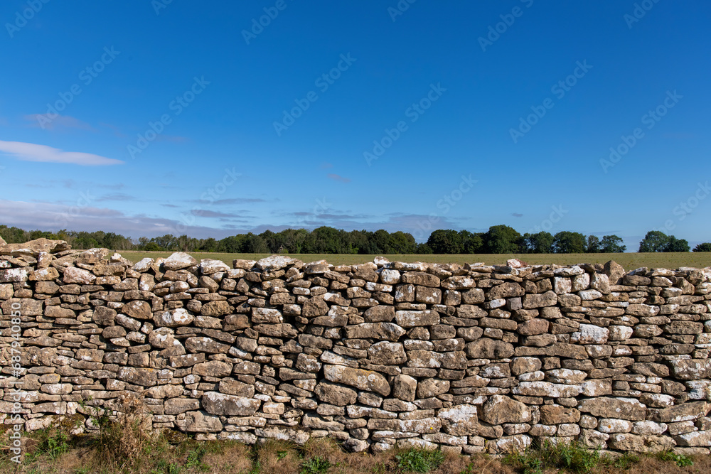 Frontal view of the limestone dry-stone walls over Lansdowne Hill in the Cotswolds as used as a defense where The First English Civil War battle of Lansdown was fought on 5 July 1643 