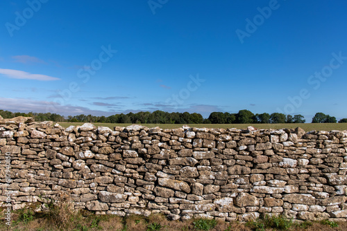 Frontal view of the limestone dry-stone walls over Lansdowne Hill in the Cotswolds as used as a defense where The First English Civil War battle of Lansdown was fought on 5 July 1643 