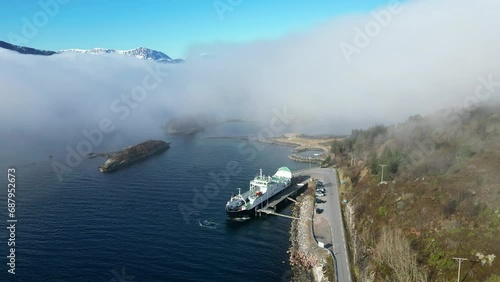 There is thick fog over the fjord when the car ferry MF 