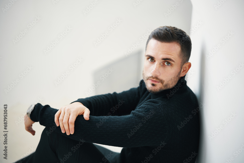 © GVS - Fashionable handsome man seated on white staircase