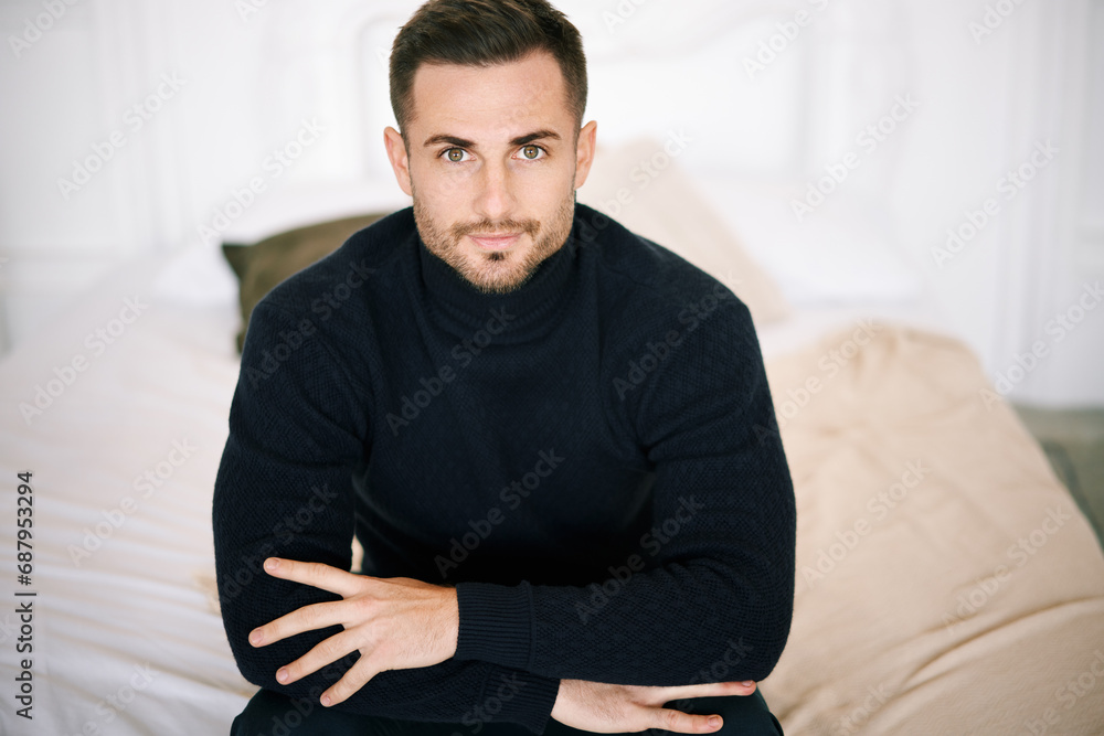 Smiling handsome young man in black clothing outfit looking confidently to camera with copy space Smiling handsome young man in black clothing outfit looking confidently to camera with copy space