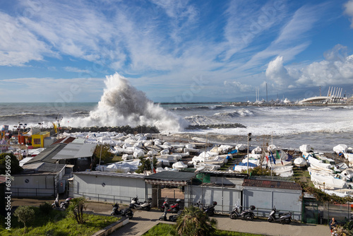 GENOA, ITALY, NOVEMBER 3, 2023 - Rough sea with big waves on the piers of the Genoa seafront, Italy photo