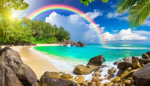 a tropical beach with a rainbow and rocks