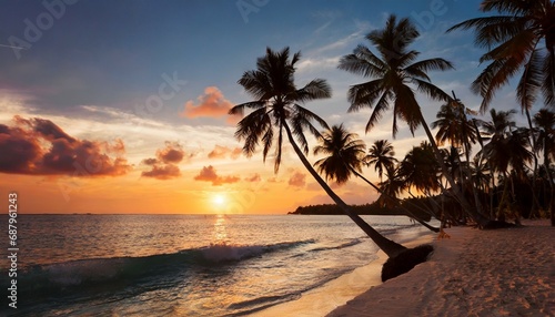 beautiful tropical beach with palm trees silhouettes at dusk © Nichole