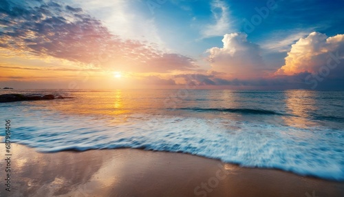 beautiful cloudscape over tropical sea and beach shore sunrise over ocean horizon © Nichole