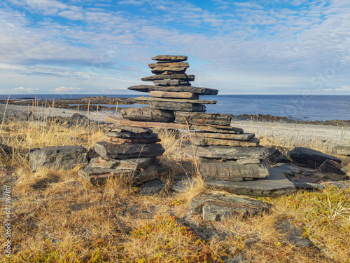 The rocky coast of the Barents Sea. Beautiful view of the rocks and the coast of the Rybachy and Sredny peninsulas, Murmansk region, Russia. The landscape is the harsh beauty of the north. photo