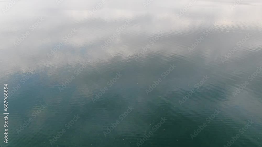 Drone view in Albania flying over Shkodër green color lake in Pogradec top view on cloudy day and mountains in the horizon Drone view in Albania flying over Shkodër green color lake in Pogradec top view on cloudy day and mountains in the horizon