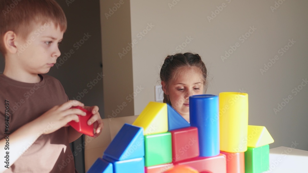 kids girl and baby play in kindergarten. a group of children play toys cubes and cars on the table in kindergarten indoor. happy family preschool education concept. nursery boy baby toddler home kids girl and baby play in kindergarten. a group of children play toys cubes and cars on the table in kindergarten indoor. happy family preschool education concept. nursery boy baby toddler home