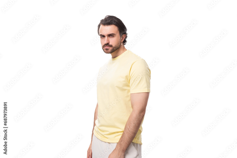caucasian brutal charming guy with a beard dressed in a summer t-shirt on a white background with copy space caucasian brutal charming guy with a beard dressed in a summer t-shirt on a white background with copy space