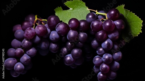 Photograph a bunch of succulent grapes, their deep purple color and plumpness on full display.