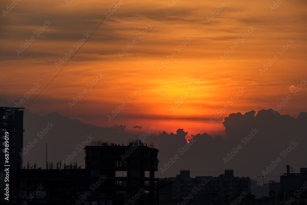Beautiful orange sky during sunset over buildings at Pune India.