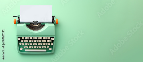 Light green typewriter on a light green background. Concept of creativity. Place for text, banner photo