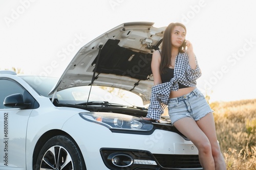 Sad woman depressed not knowing what to do with broken car © Serhii